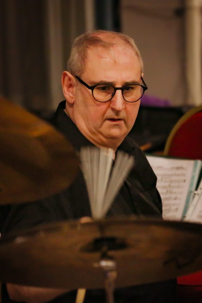 Drummer performing in black and white