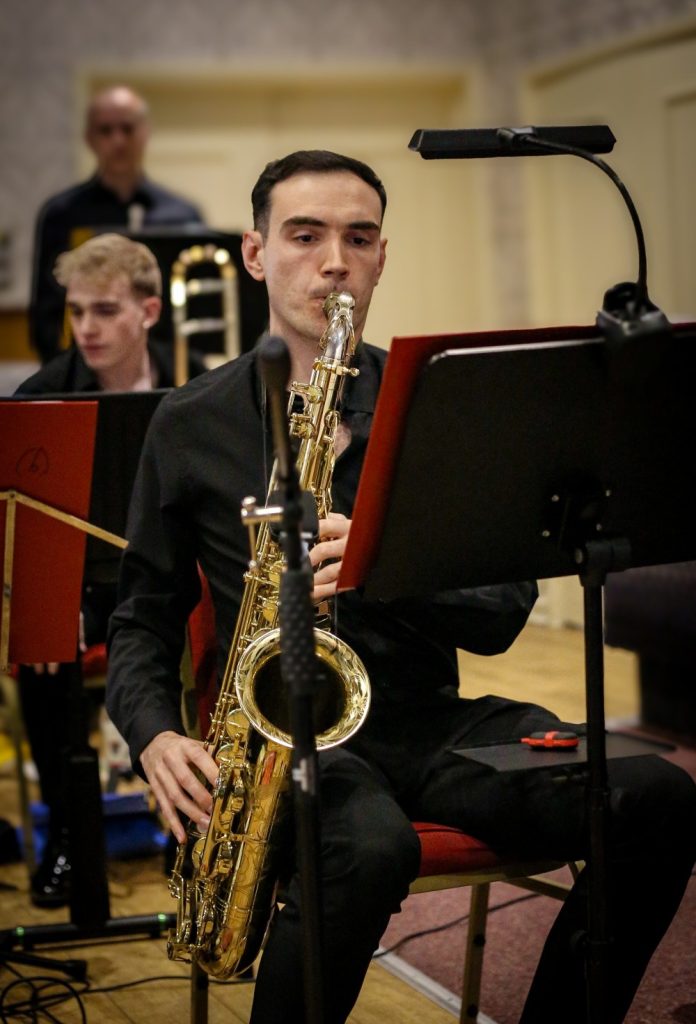 Saxophonist playing in ensemble